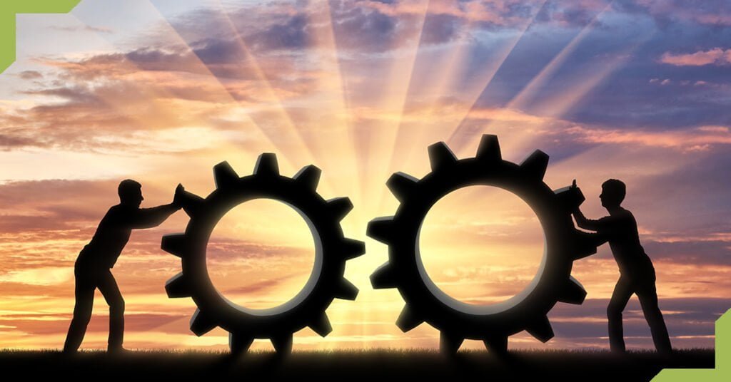 Two people pushing giant gears to symbolize software development productivity