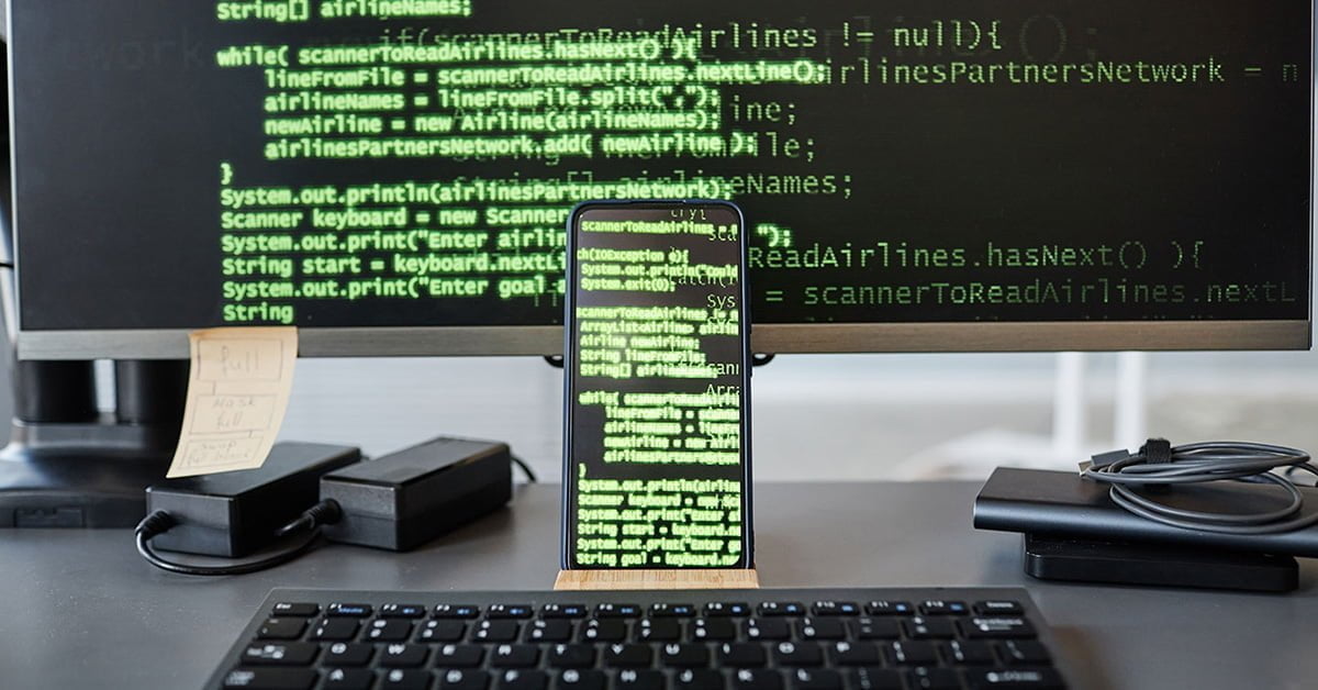 A visual illustration of device screens filled with code while creating mobile app development