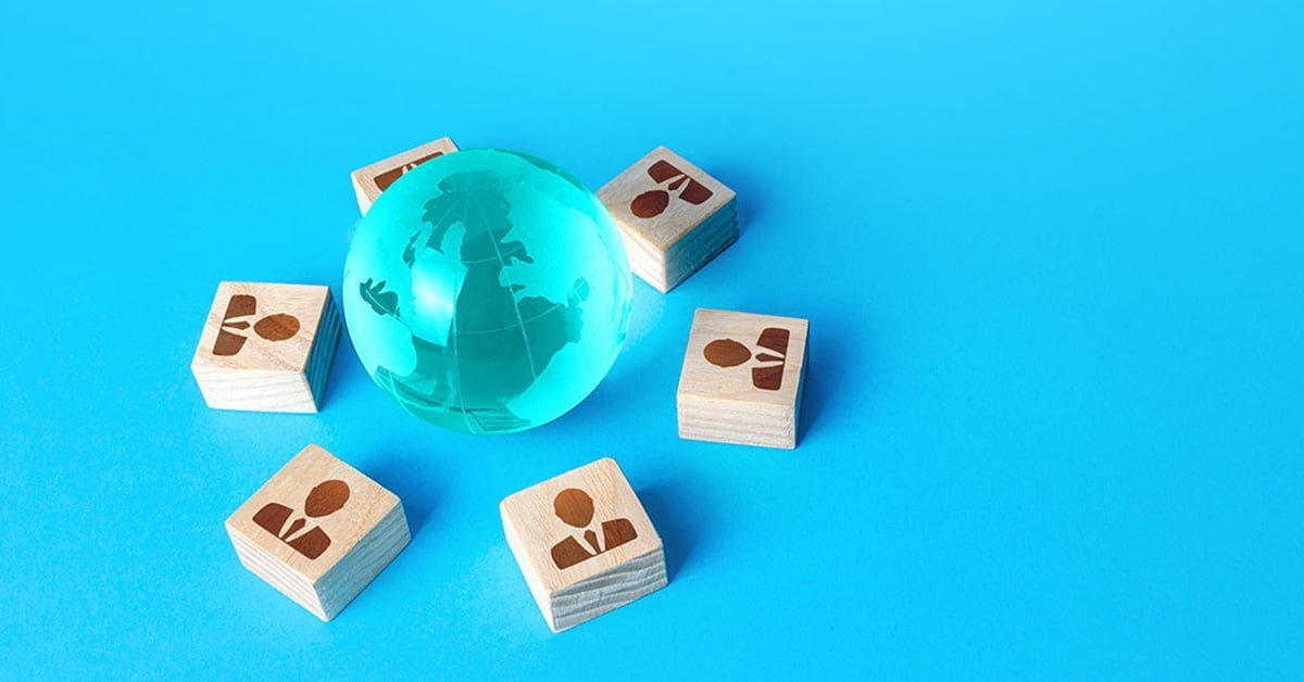 Globe and people blocks illustrating how to scale software development by outsourcing